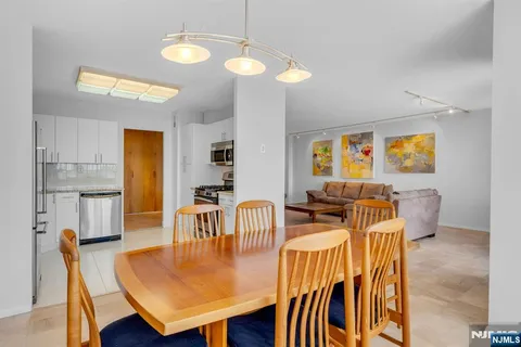 a view of a dining room with furniture and a chandelier