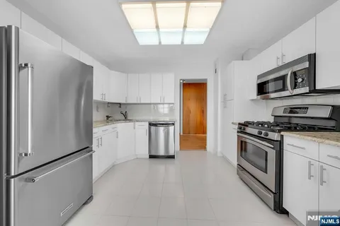 a kitchen with stainless steel appliances a refrigerator stove and microwave