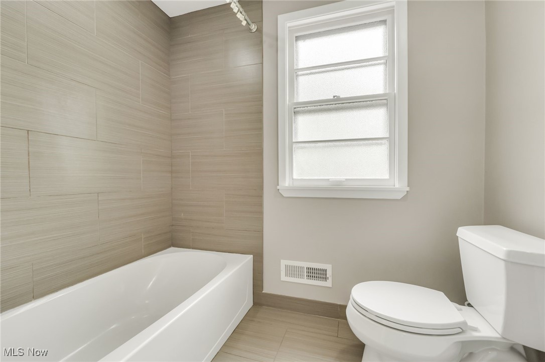 2524 Claver Road Cleveland, OH 44118 - Photo 41 of 50 Bathroom featuring toilet, baseboards, and shower / bath combination