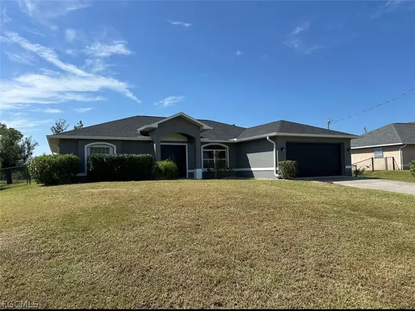 a front view of a house with a garden and yard