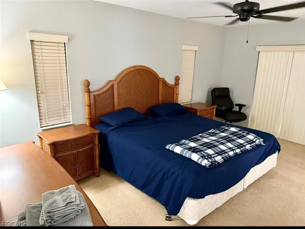 a bedroom with a bed window and dresser