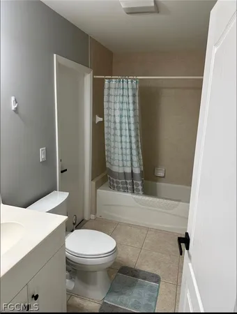 a bathroom with a toilet a sink and shower