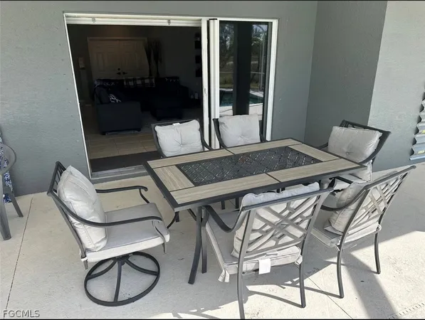 a balcony with table and chairs