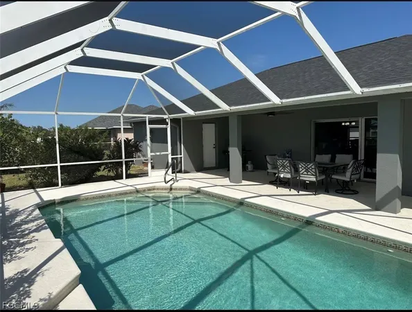 a view of a backyard with swimming pool and porch