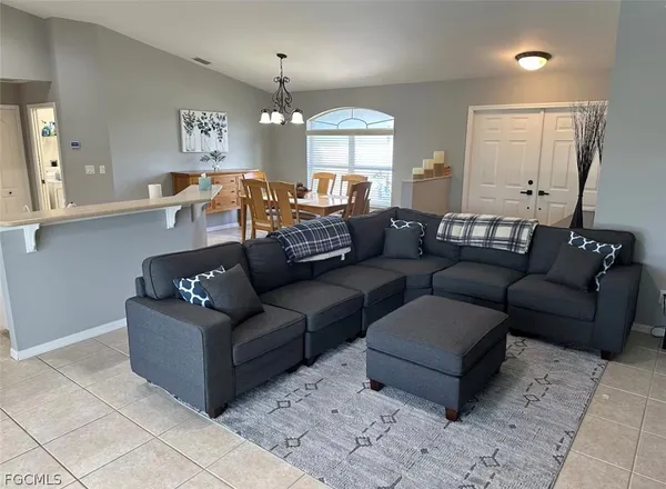 a living room with furniture and a chandelier