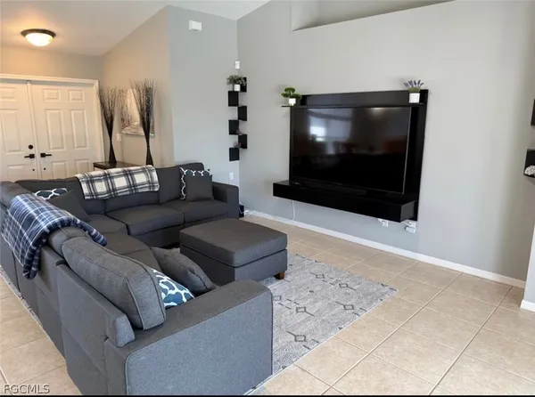 a living room with furniture and a flat screen tv