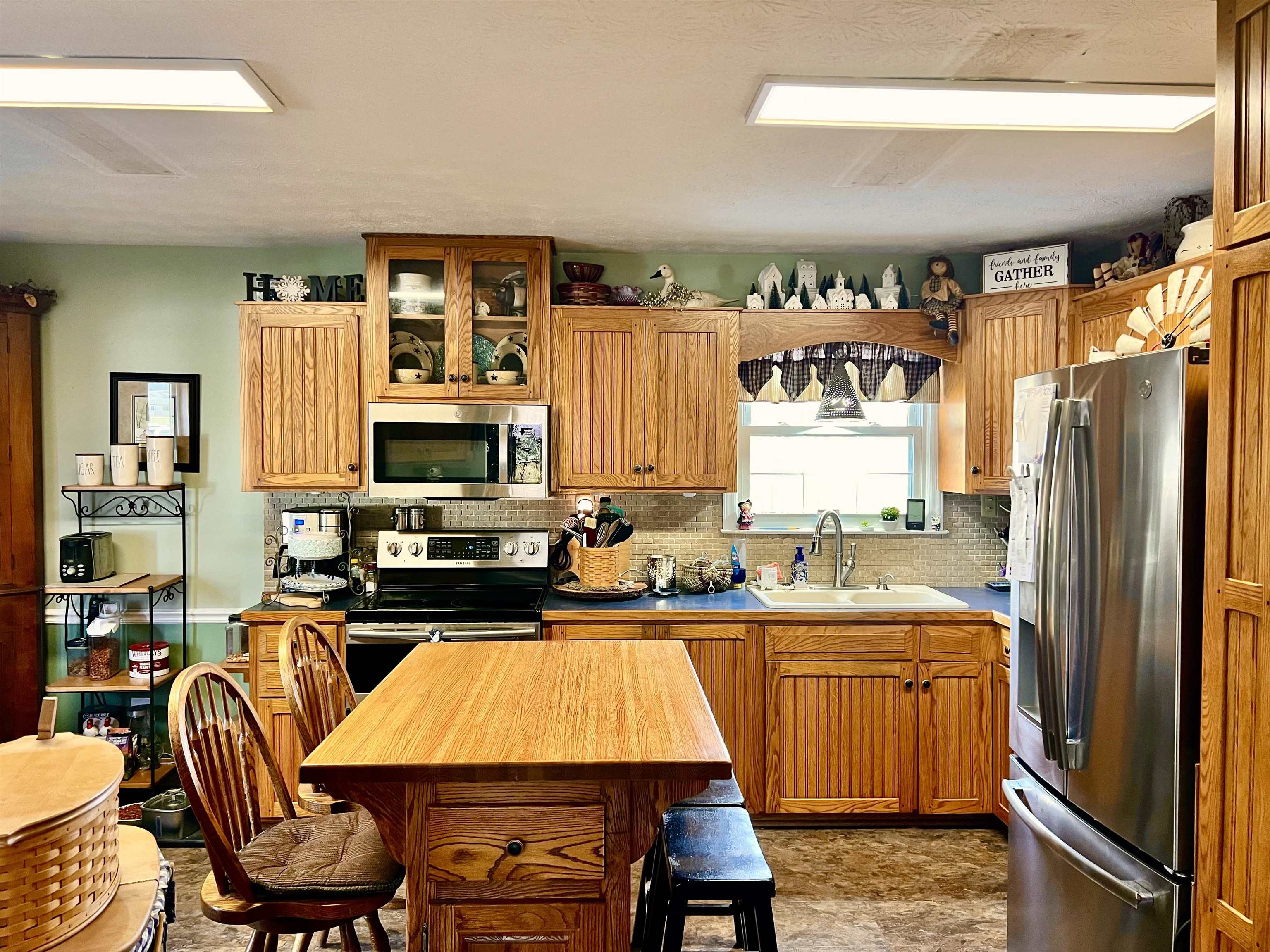 8346 Spring Creek Road Bridgewater, VA 22812 - Photo 9 of 16 a kitchen with a table chairs refrigerator and cabinets