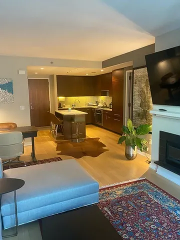 a living room with fireplace furniture and a flat screen tv