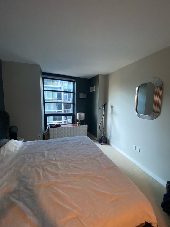580 Washington Street, Unit 711 Boston, MA 02111 - Photo 5 of 7 a view of empty room with a window