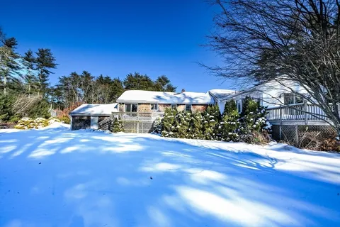 a view of a big yard with an outdoor seating