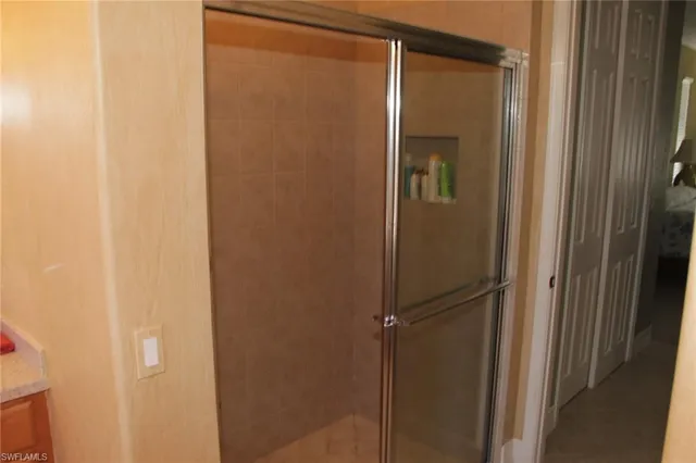 a bathroom with a glass shower door