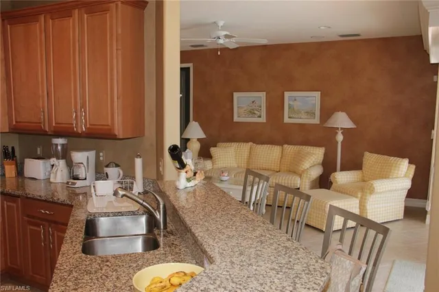 a kitchen with stainless steel appliances granite countertop a refrigerator sink and stove