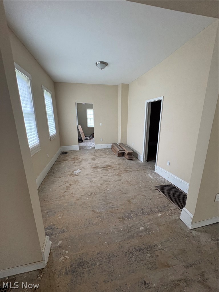 1210 Lawrence Road Northeast Canton, OH 44705 - Photo 12 of 38 Neutral wall tones, multiple windows with blinds, recessed ceiling light fixture, and white trim