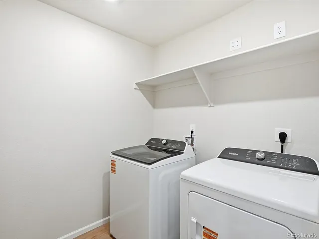 a bathroom with a toilet sink vanity and shower