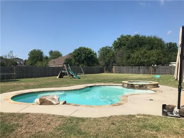 a view of a swimming pool with a yard