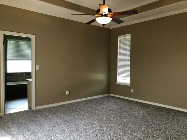en empty room with windows and fan