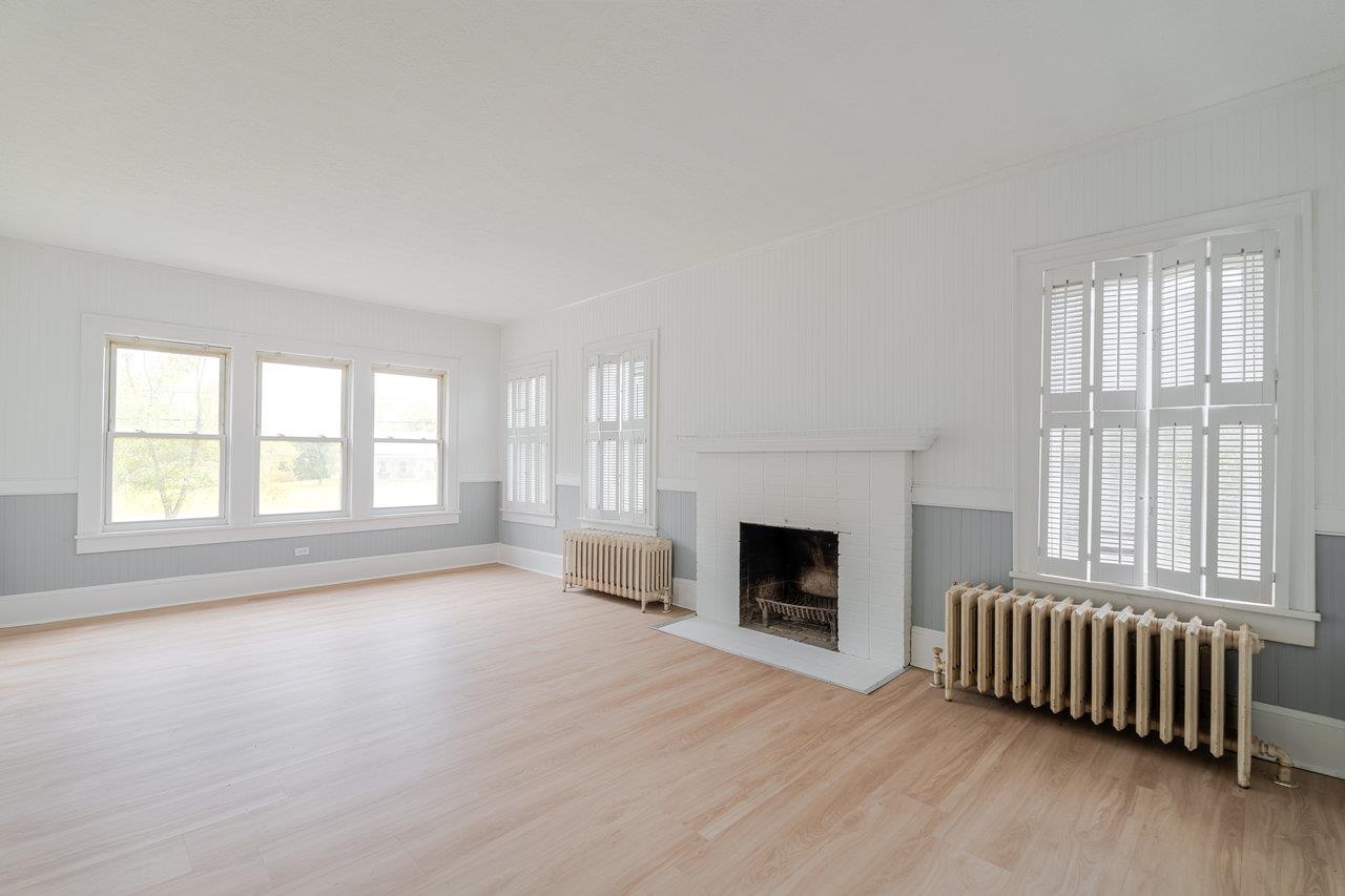 9571 Town Hall Road McGaheysville, VA 22840 - Photo 12 of 66 a view of an empty room with wooden floor fireplace and a window