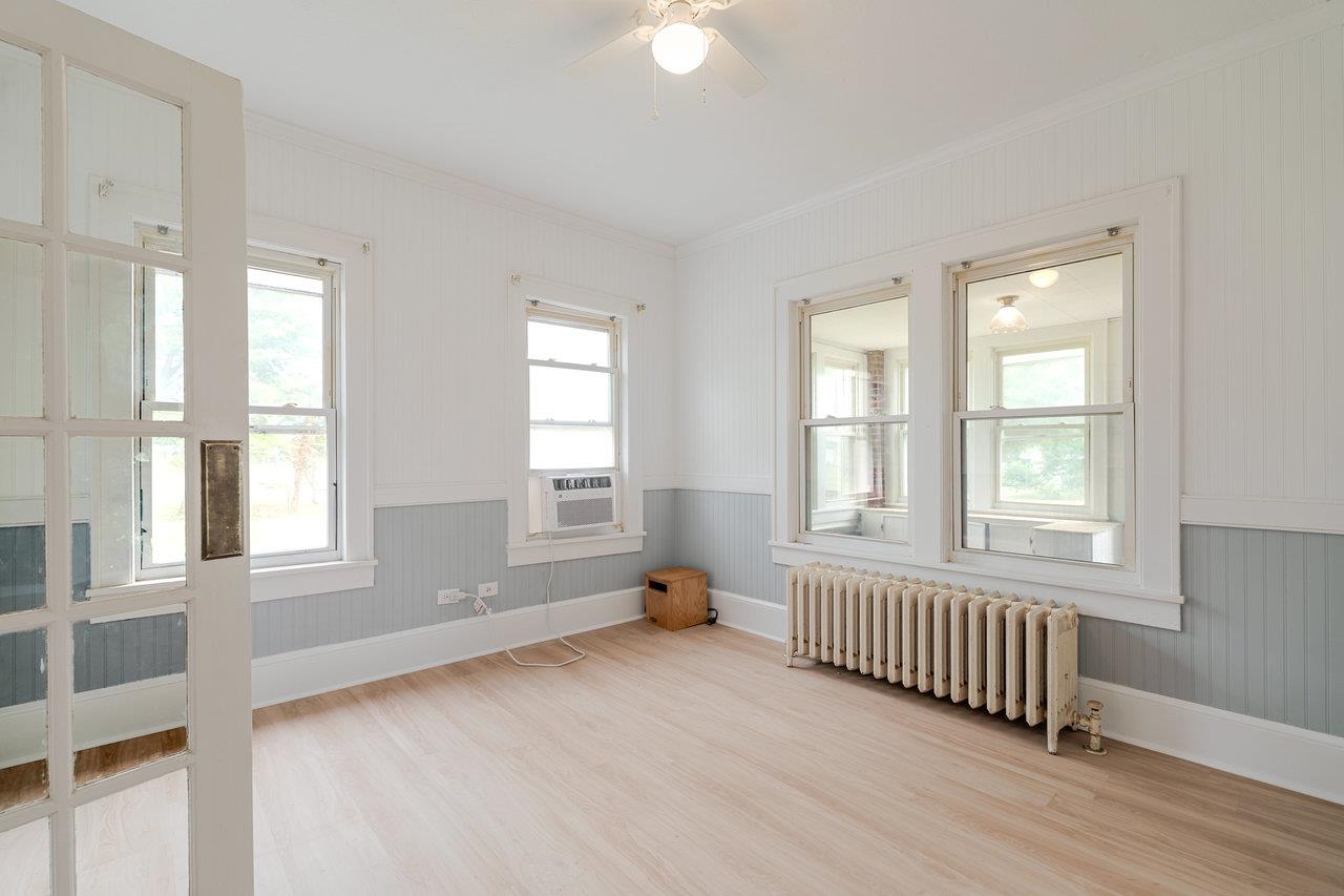 9571 Town Hall Road McGaheysville, VA 22840 - Photo 15 of 66 an empty room with wooden floor and windows