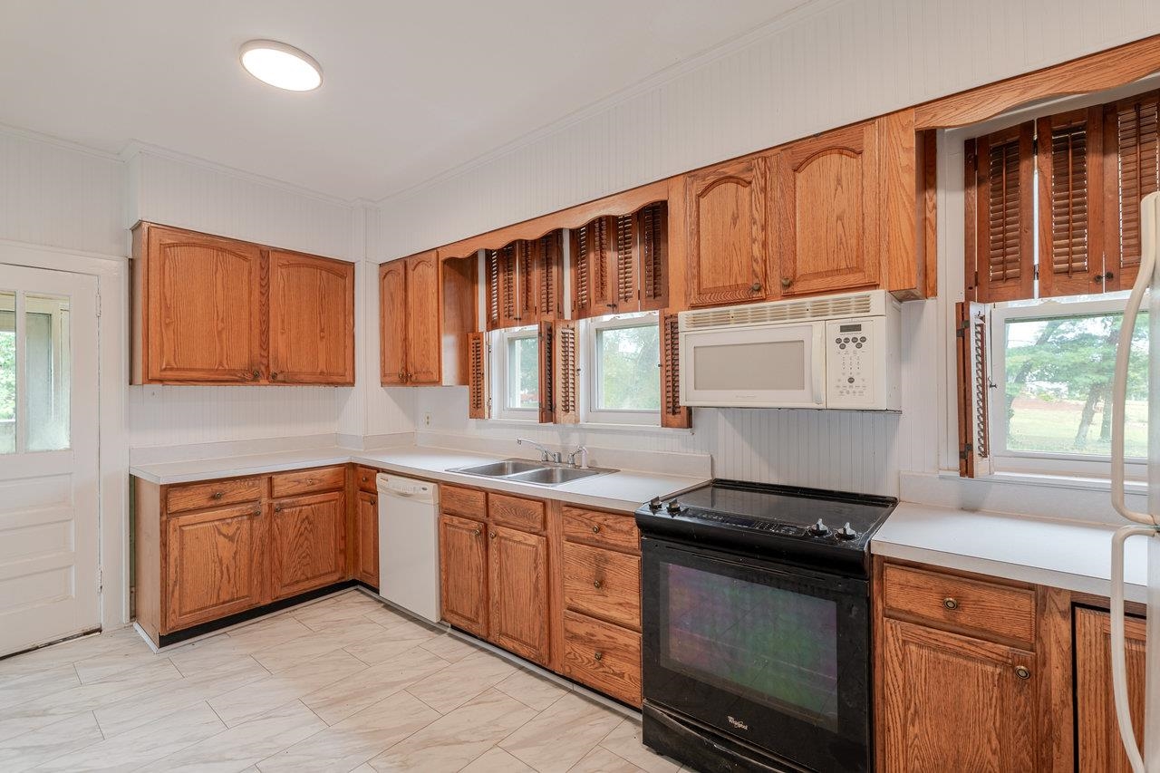 9571 Town Hall Road McGaheysville, VA 22840 - Photo 19 of 66 a kitchen with stainless steel appliances granite countertop a stove a sink and a microwave