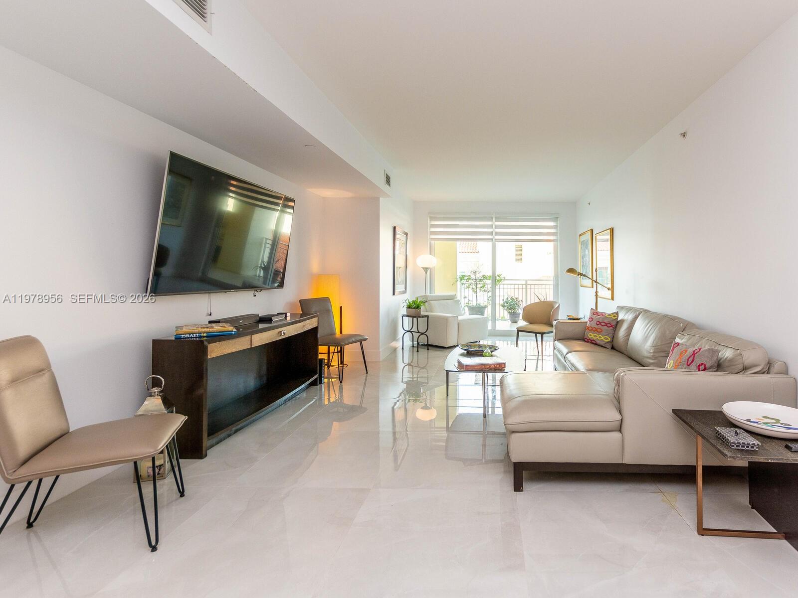 7350 Southwest 89th Street, Unit 719S Miami, FL 33156 - Photo 10 of 30 a living room with furniture and a flat screen tv