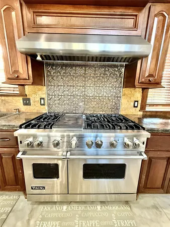 a stove top oven sitting inside of a kitchen