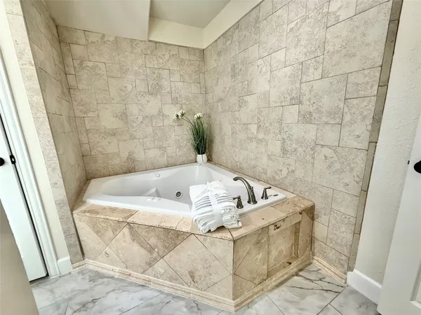a spacious bathroom with a granite countertop sink and a mirror