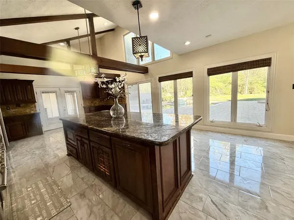 a kitchen with stainless steel appliances granite countertop a sink and wooden cabinets