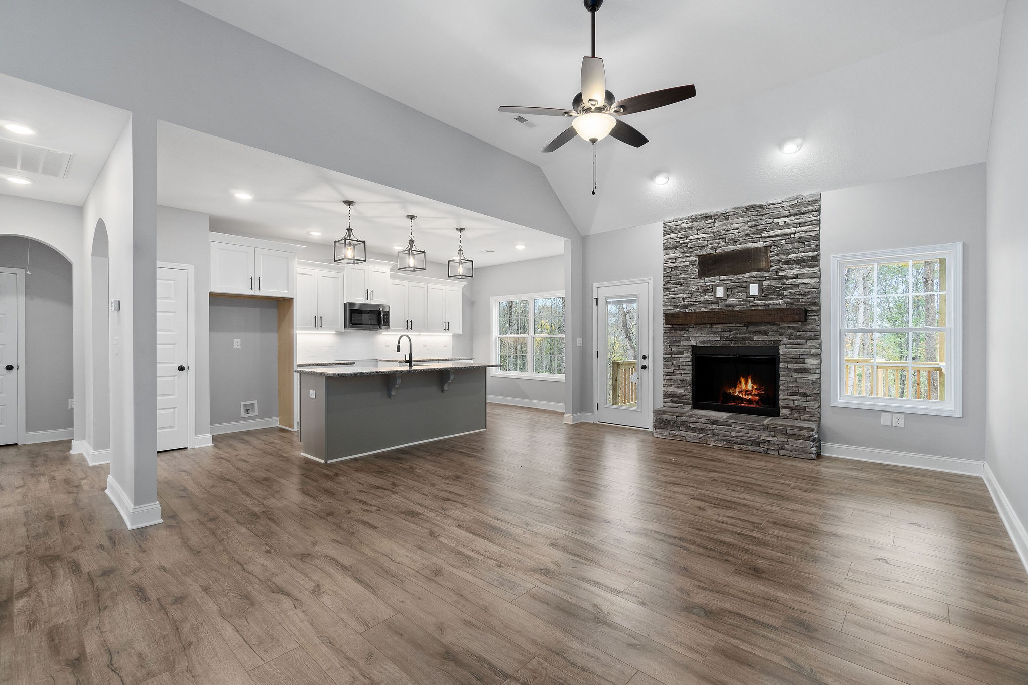 2790 Russell Road Palmyra, TN 37142 - Photo 2 of 31 a view of an empty room with kitchen and fireplace