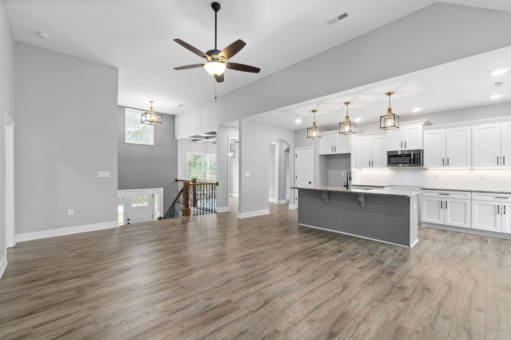 2790 Russell Road Palmyra, TN 37142 - Photo 3 of 31 a large white kitchen with wooden floors and a fireplace