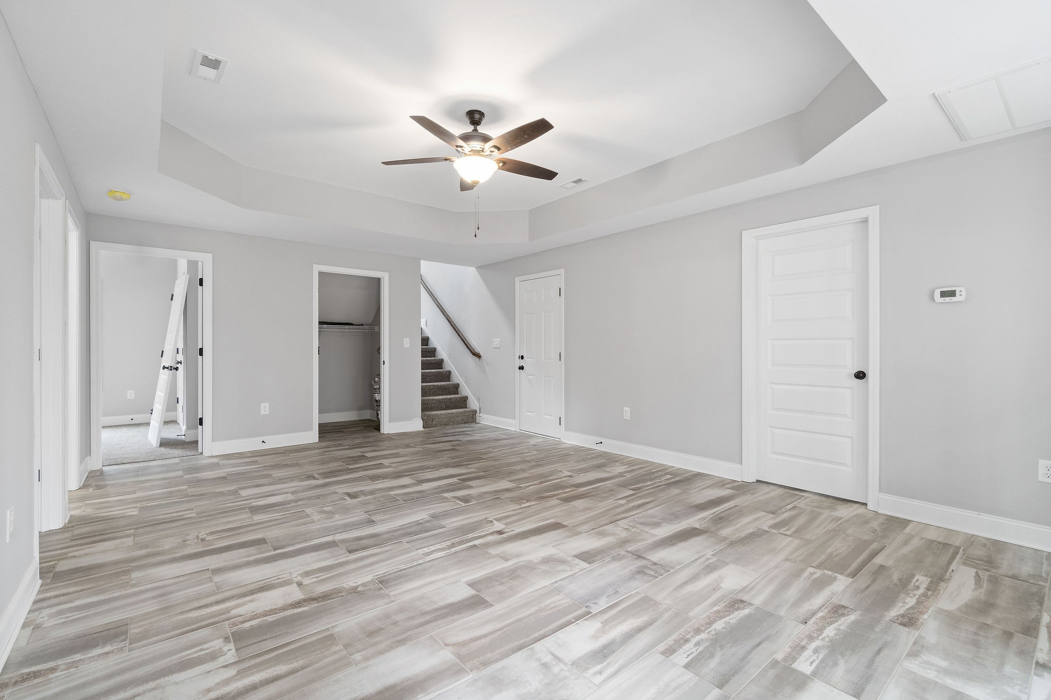 2790 Russell Road Palmyra, TN 37142 - Photo 23 of 31 a view of an empty room with wooden floor and a ceiling fan