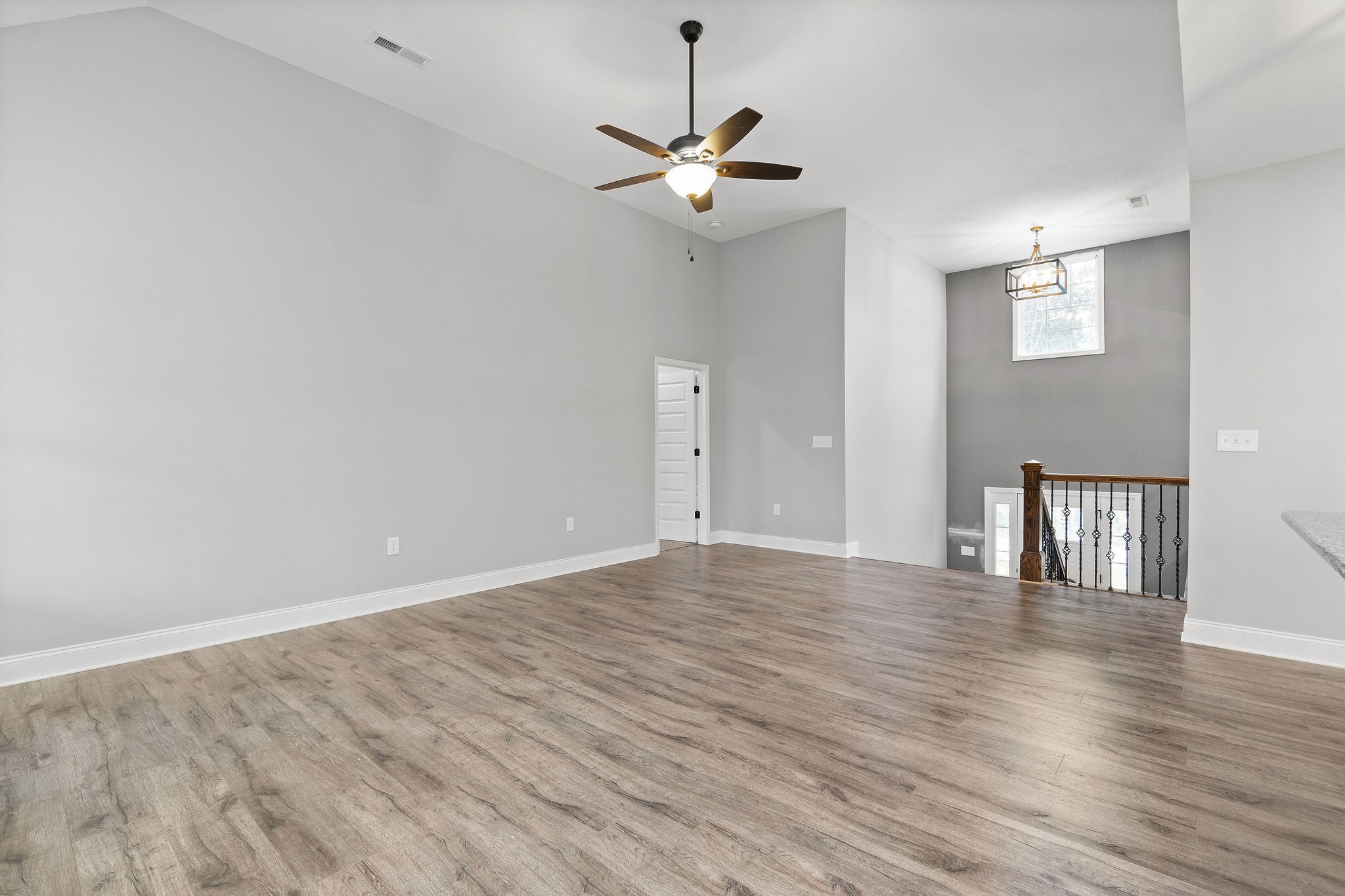 2790 Russell Road Palmyra, TN 37142 - Photo 4 of 31 a view of an empty room with wooden floor and a ceiling fan