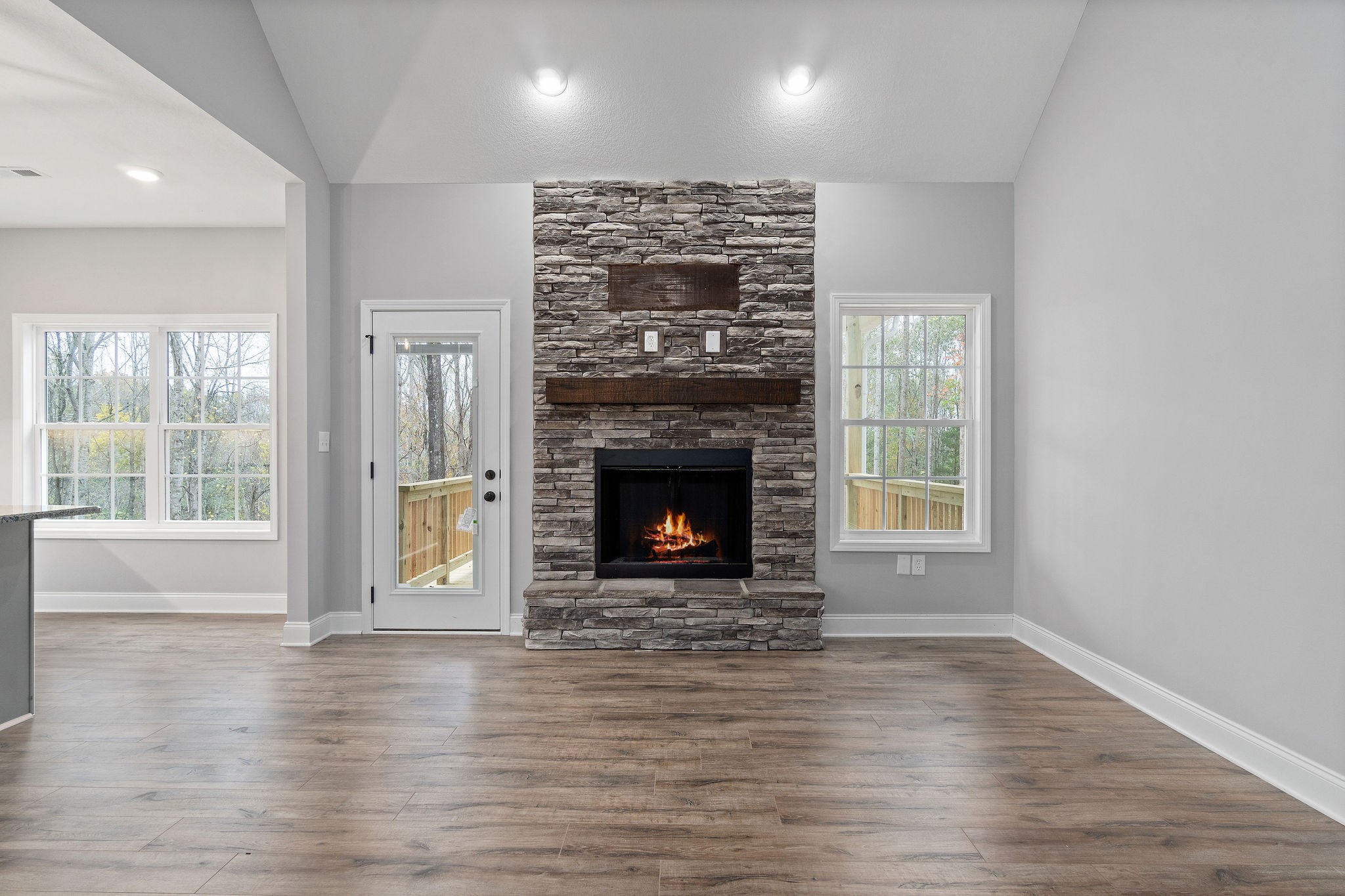 2790 Russell Road Palmyra, TN 37142 - Photo 6 of 31 a view of a livingroom with a fireplace wooden floor and window