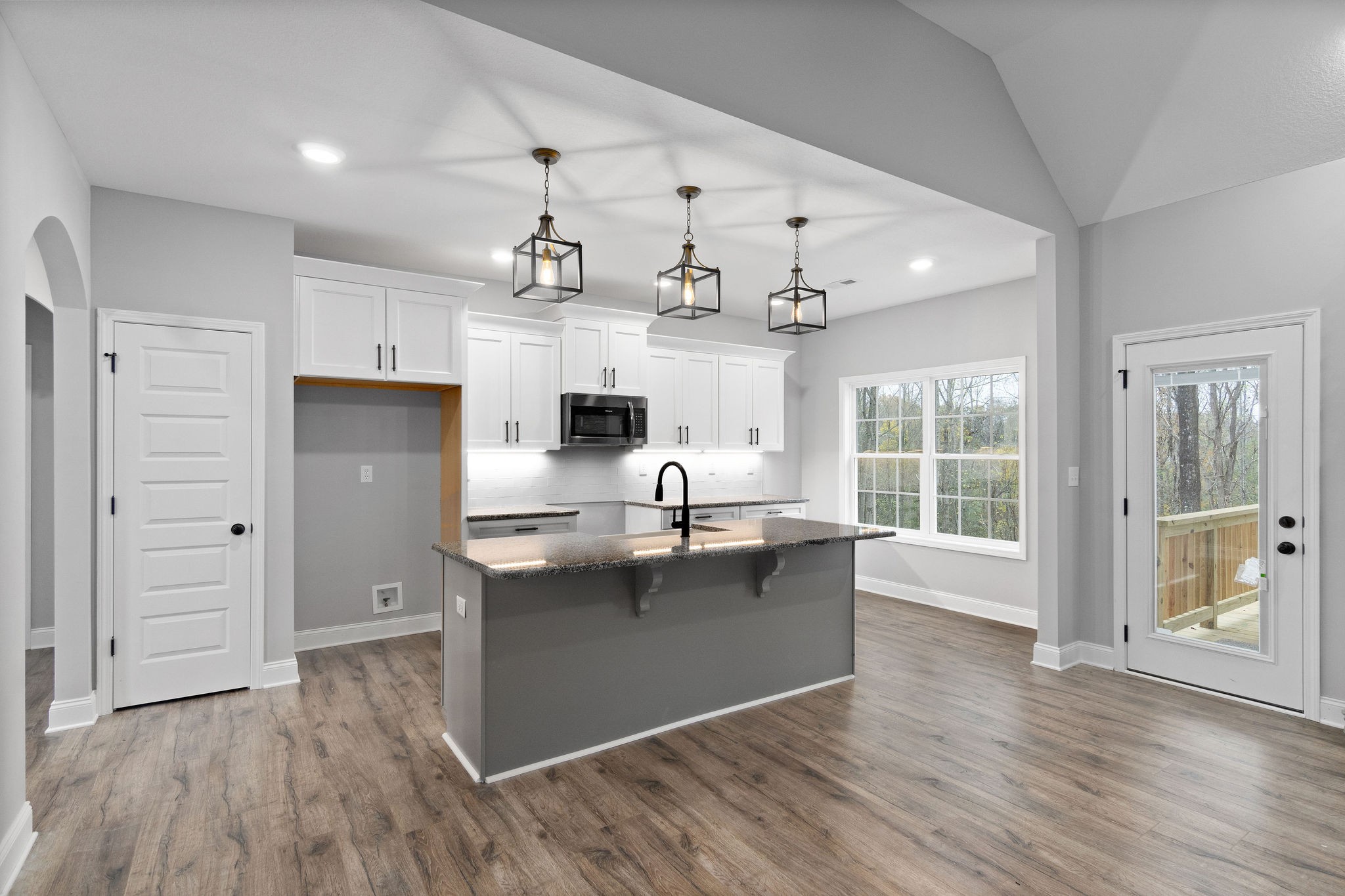 2790 Russell Road Palmyra, TN 37142 - Photo 7 of 31 a living room with kitchen island granite countertop wooden floor and stainless steel appliances