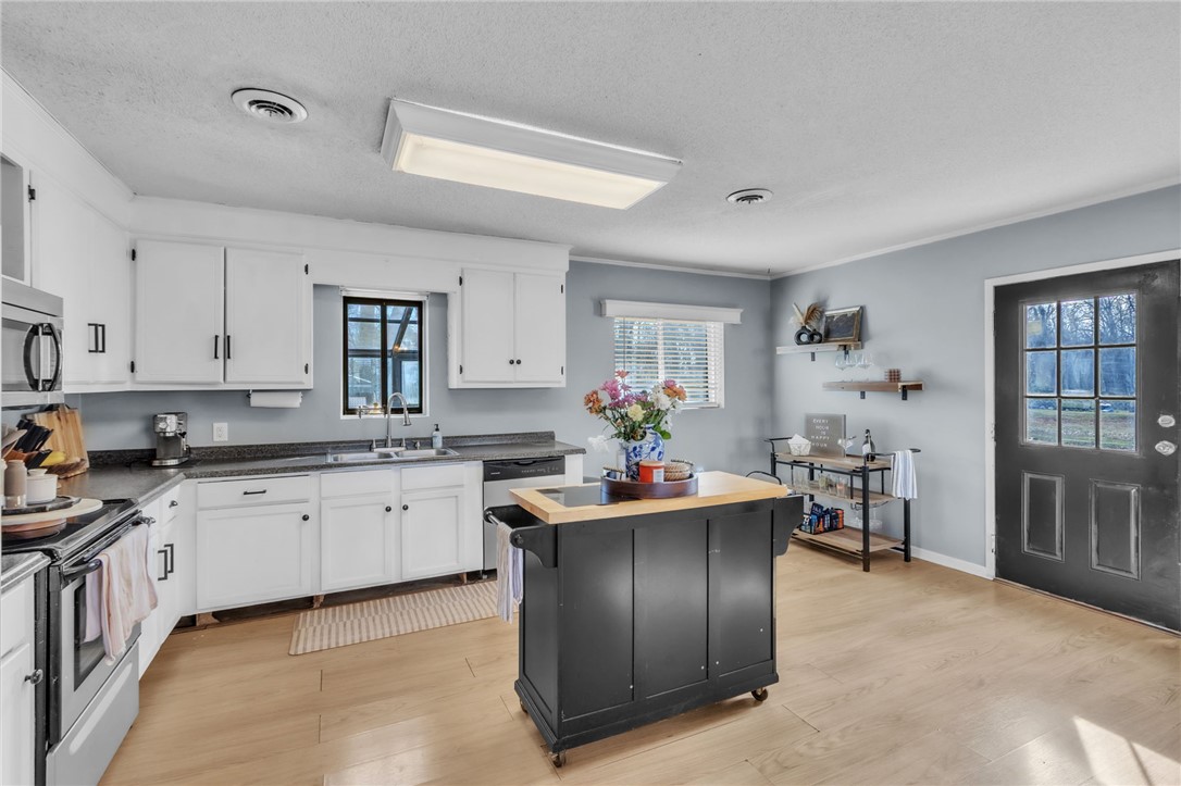 139 Louise Drive Pendleton, SC 29670 - Photo 11 of 26 This kitchen features light wood flooring and sleek appliances.