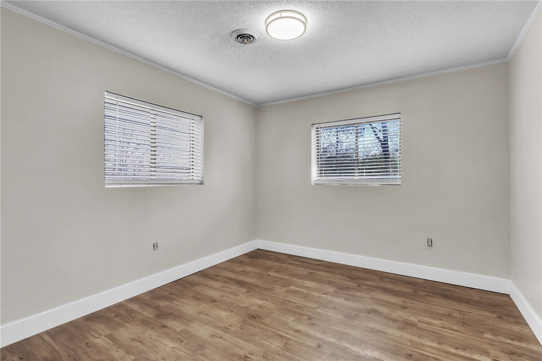 139 Louise Drive Pendleton, SC 29670 - Photo 17 of 26 This spacious bedroom features warm hardwood flooring, two sunlit windows, and an inviting atmosphere.