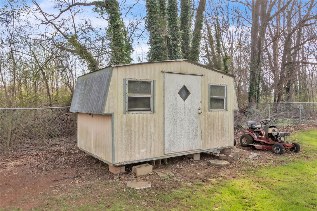 139 Louise Drive Pendleton, SC 29670 - Photo 22 of 26 This outdoor storage shed offers practical space for tools and equipment within the yard.