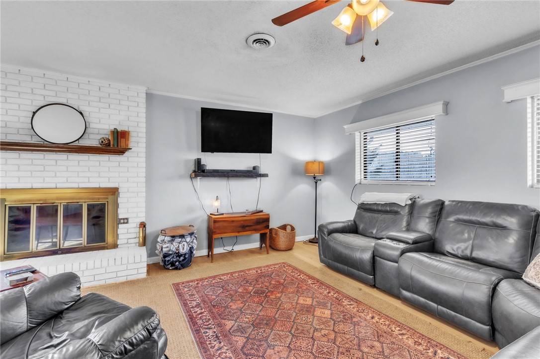 139 Louise Drive Pendleton, SC 29670 - Photo 4 of 26 This inviting living area features a charming fireplace and warm flooring, perfect for relaxed gatherings.