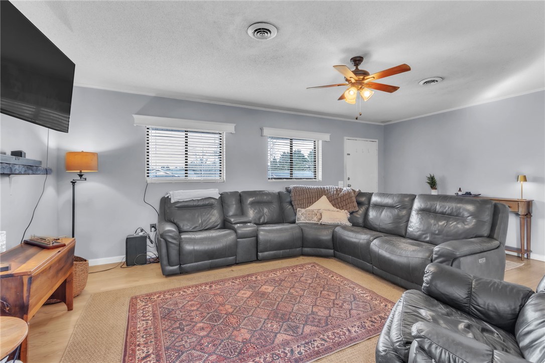 139 Louise Drive Pendleton, SC 29670 - Photo 6 of 26 This inviting living area features warm flooring and a ceiling fan, creating a comfortable gathering space.