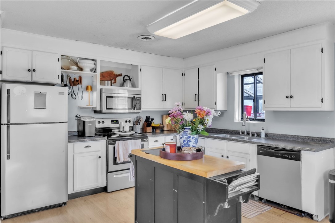 139 Louise Drive Pendleton, SC 29670 - Photo 9 of 26 This bright kitchen features classic white cabinetry and practical appliances, perfect for daily living.