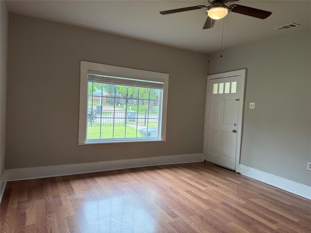 801 Wayne Street Dallas, TX 75223 - Photo 2 of 15 an empty room with wooden floor and windows
