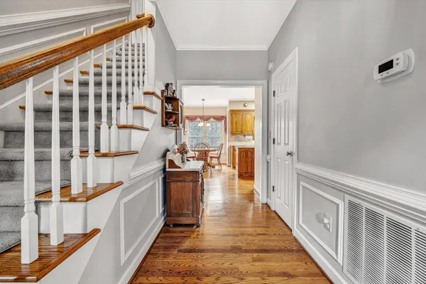 a hallway with a large window and wooden floor