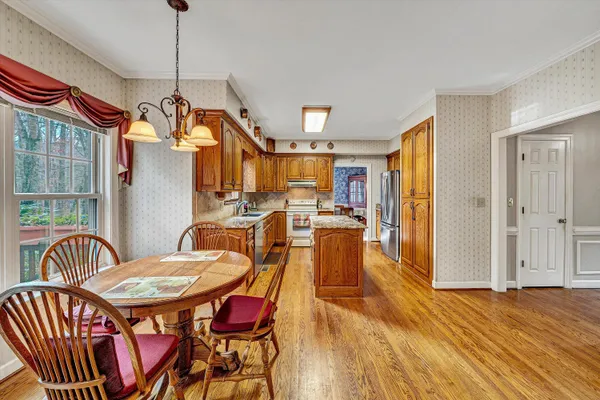 a view of a dining room with furniture window and wooden floor