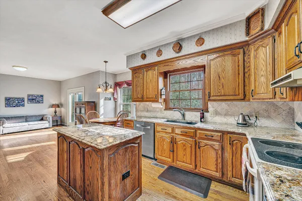 a kitchen with a sink stove and cabinets