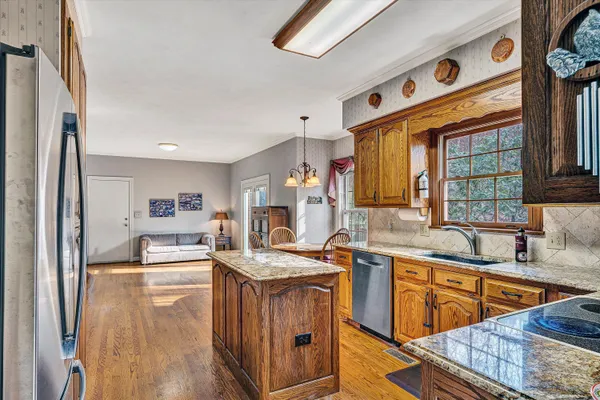 a kitchen with stainless steel appliances granite countertop a sink stove and refrigerator