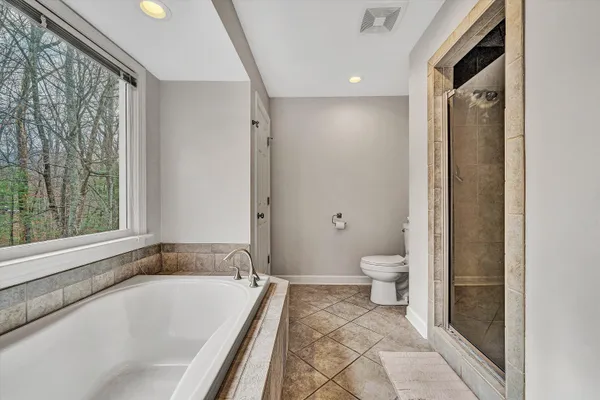 a bathroom with a granite countertop toilet a sink and a bathtub