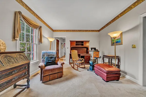 a bedroom with furniture and a book shelf