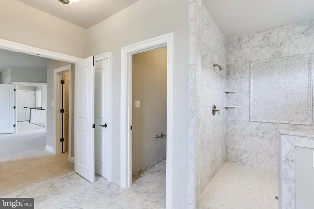 a bathroom with a granite countertop sink a toilet and bathtub