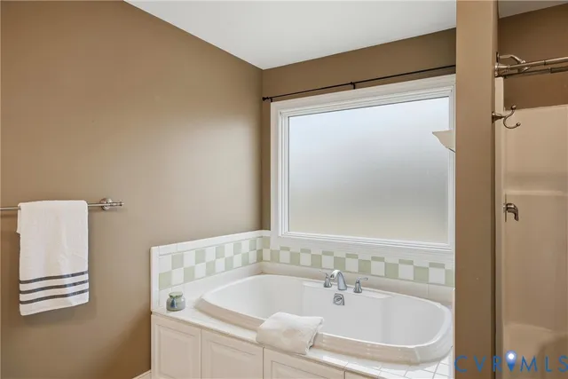 a view of a white house with a yard and sitting area