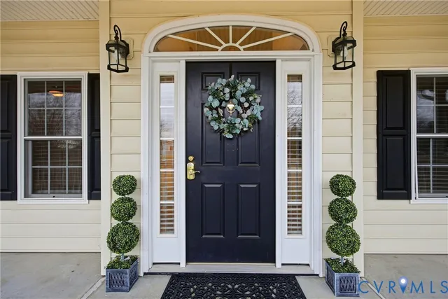 a front view of a house with potted plants