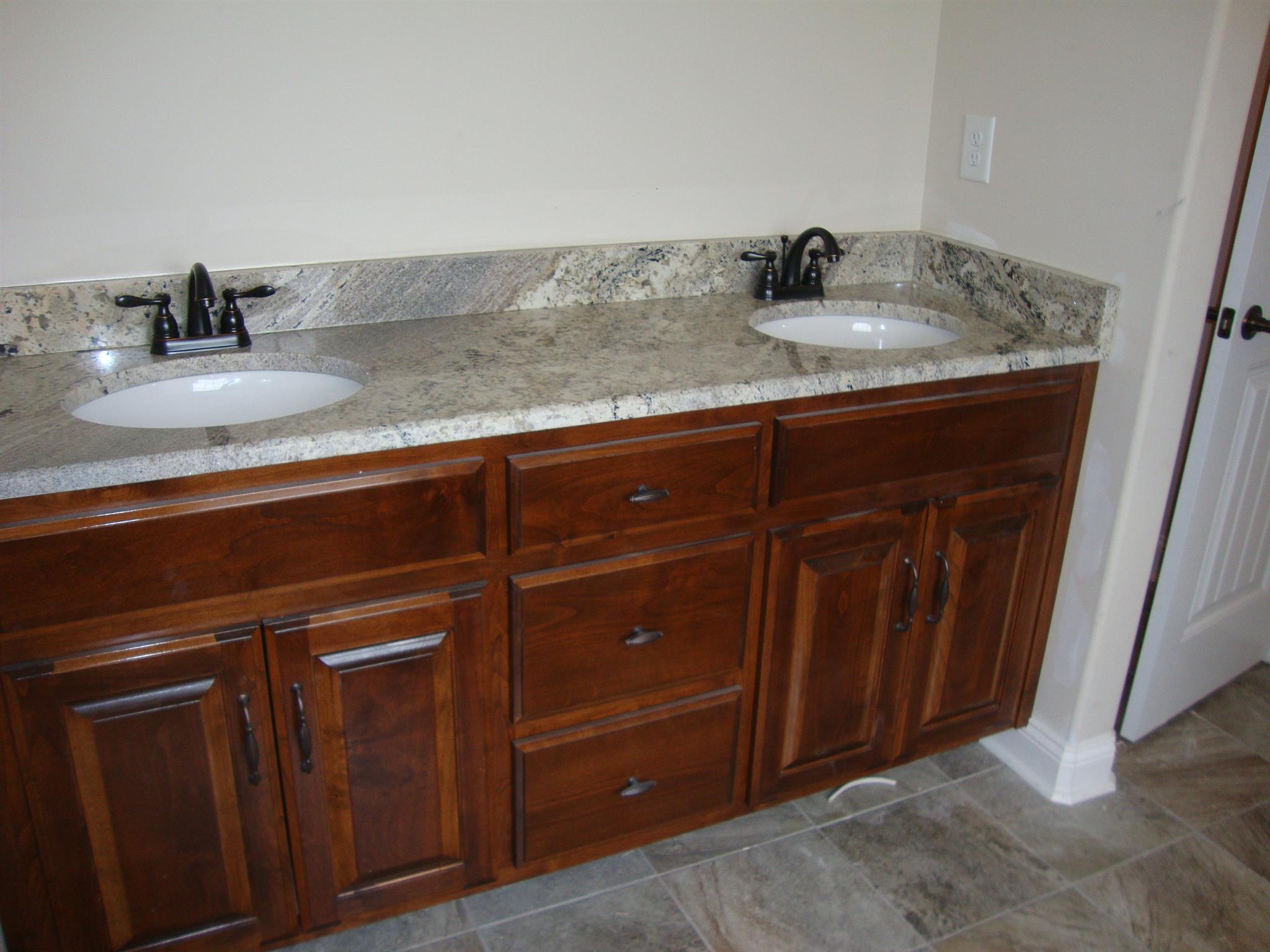3596 Drake Road Adams, TN 37010 - Photo 12 of 25 a sink with granite countertop cabinets and utility room